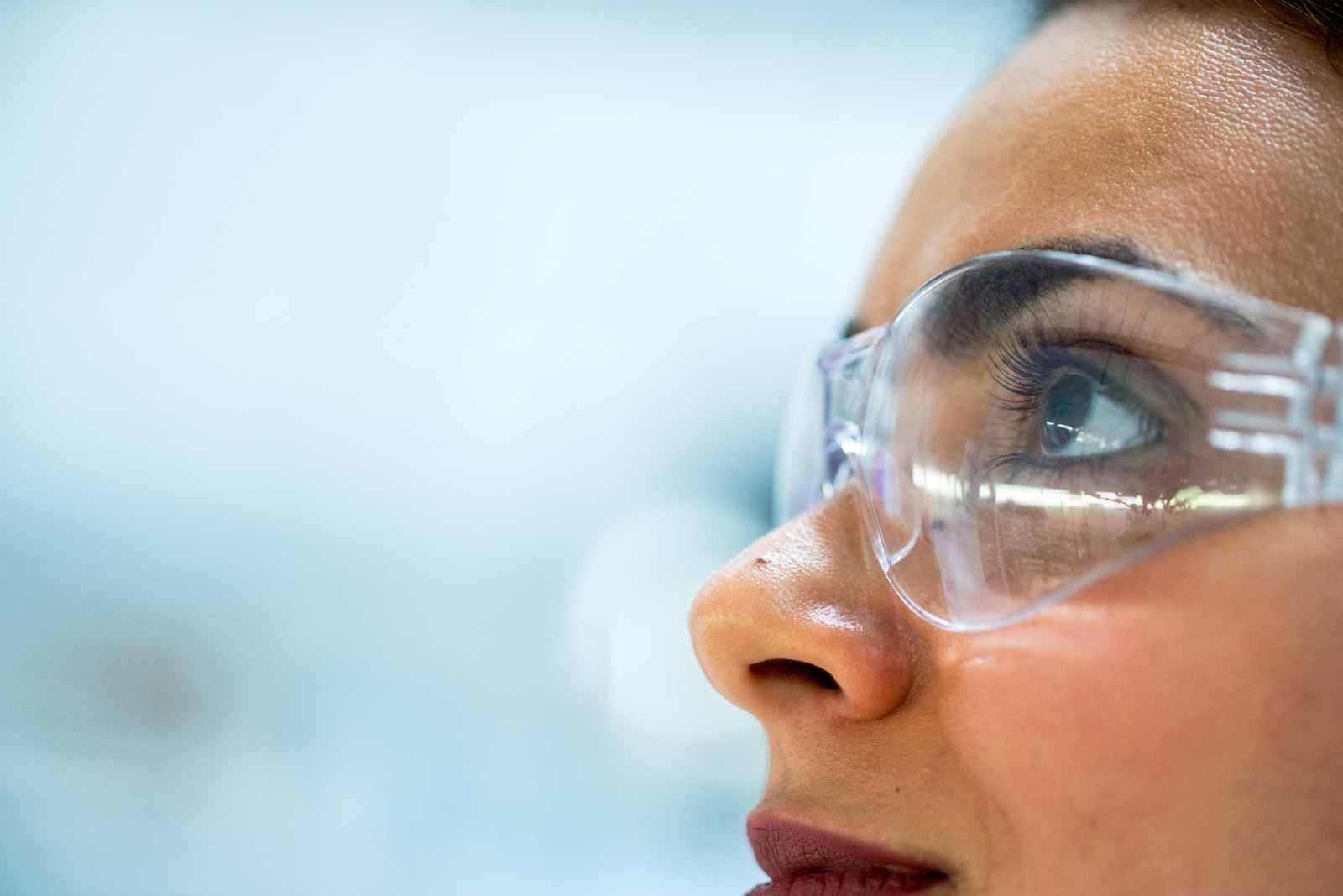 Researcher in a laboratory wearing safety goggles